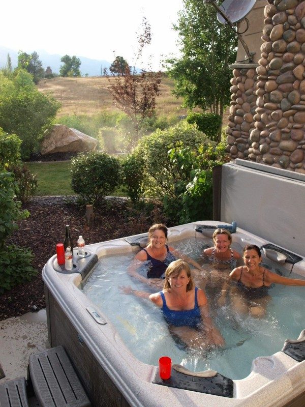 Guests in the private hot tub outside the lower level