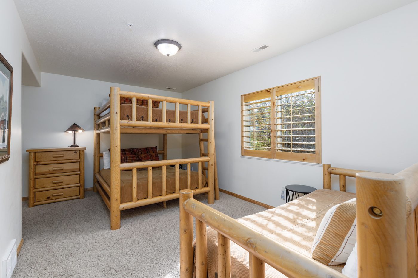 Lower-level bunk room with log-frame bunk beds