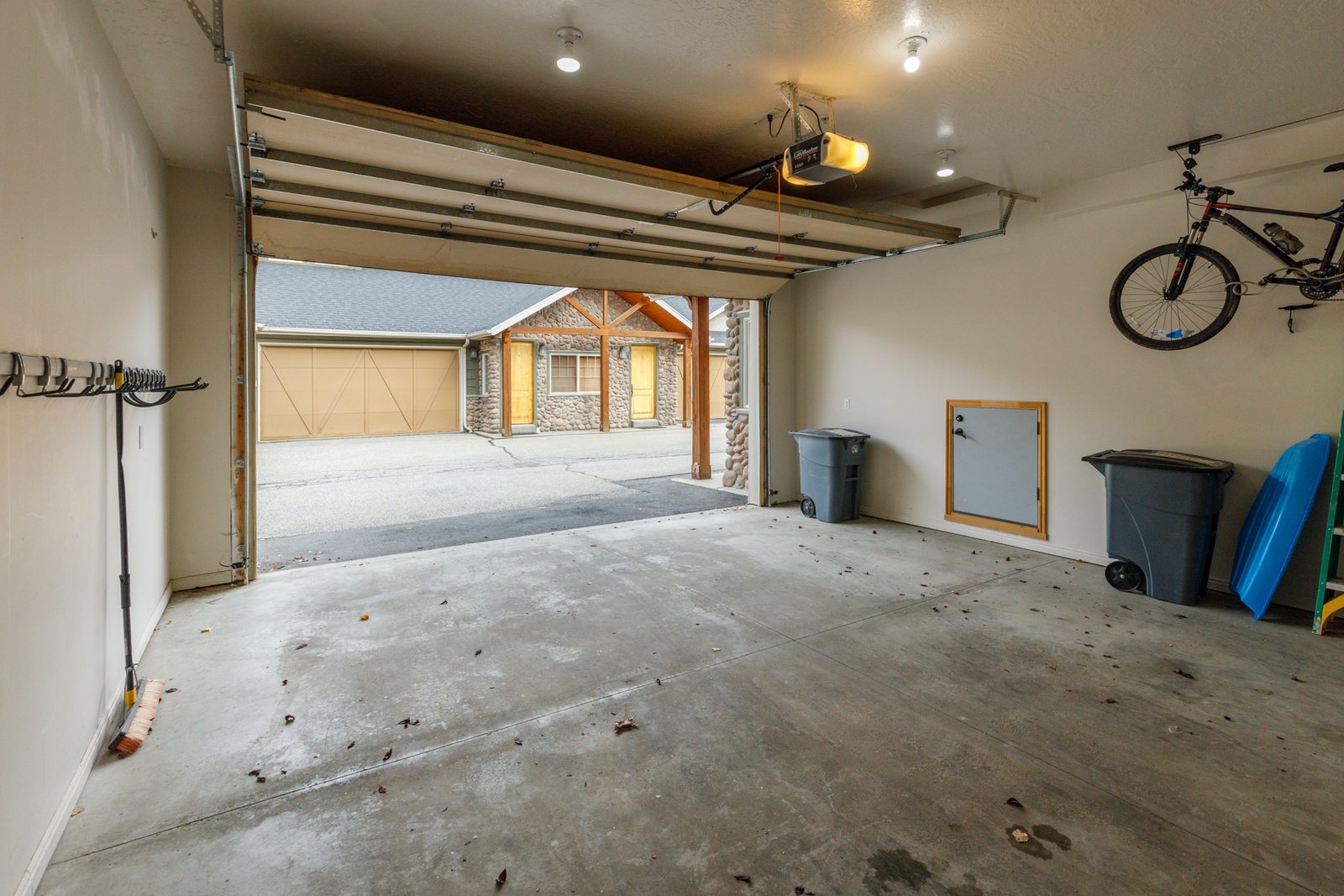 The attached two-car garage with racks for skis and snowboards