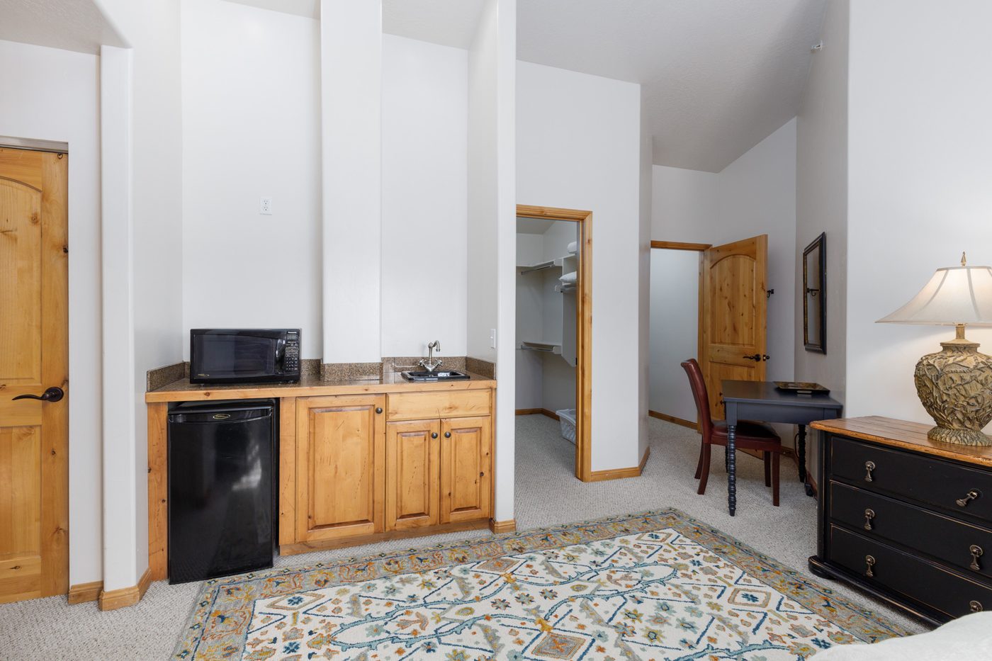 Kitchenette in the upper primary suite with microwave, sink and refrigerator