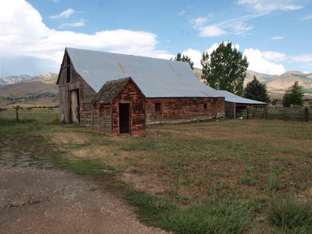A weathered timber barn in the hay fields near Eden with the mountains behind
